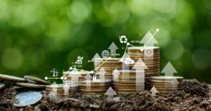 Investment Ideas And Business Growth. Coins Stacked On The Ground With A Digital Graph. Green Business Growth. Finance Sustainable Development. Investing In Renewable Energy Is Crucial For The Future.