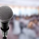 Microphone On Stage In Conference Hall.
