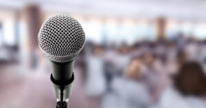 Microphone On Stage In Conference Hall.